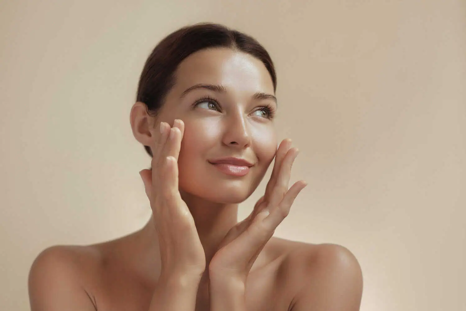 a woman touching her face after 60 minutes facial