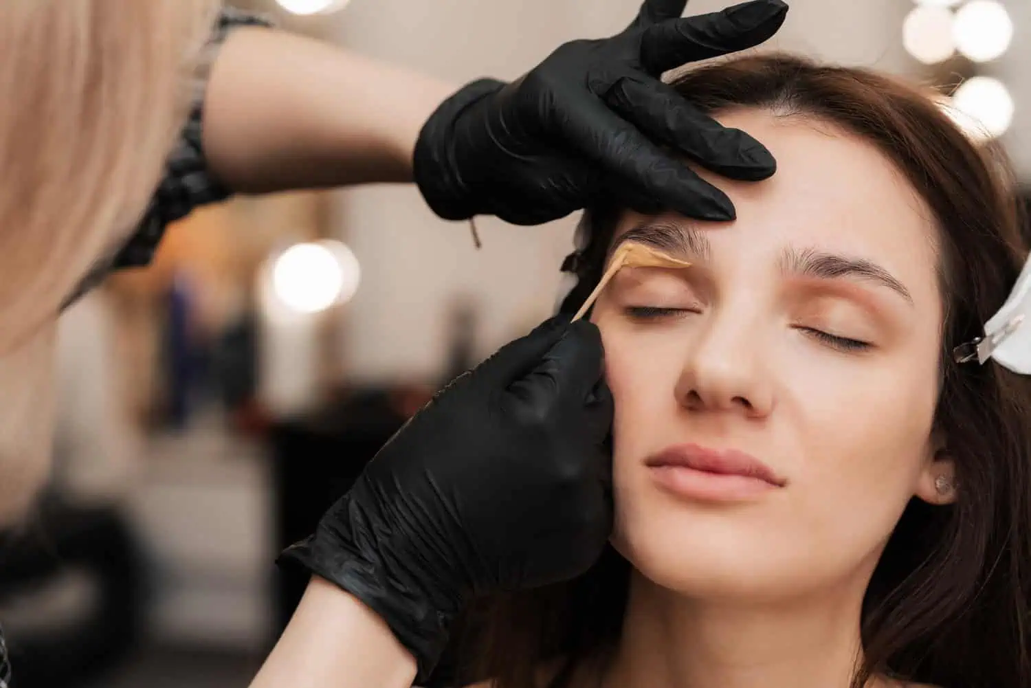 woman getting her eyebrows waxing